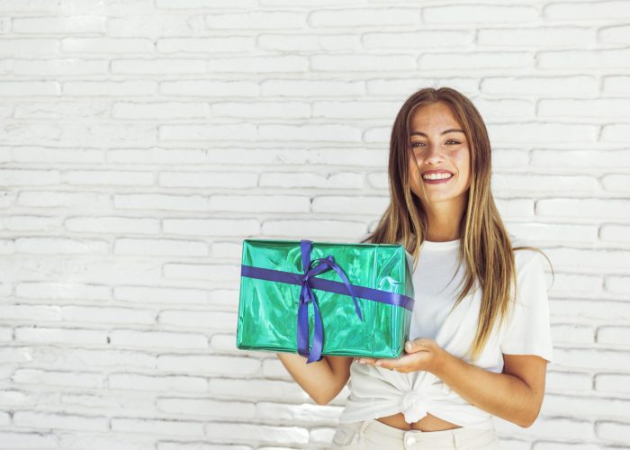 happy-woman-holding-green-gift-box