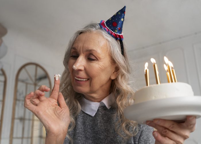 medium-shot-old-woman-holding-cake